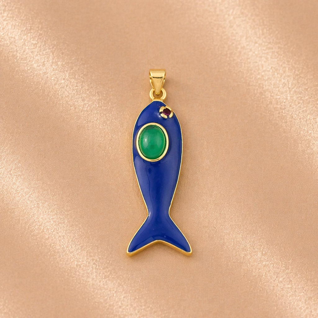 Blue fish-shaped pendant with a green gemstone on a beige background