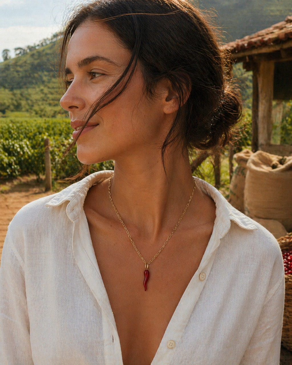 Woman wearing a necklace with a red pendant in an outdoor setting