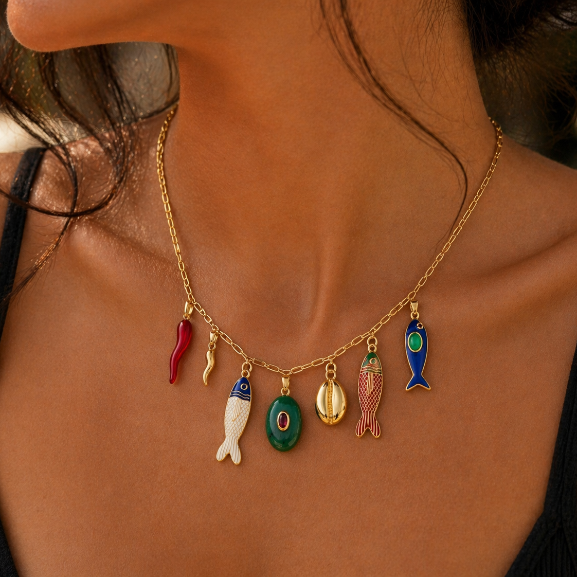 Necklace with colorful fish charms worn by a person