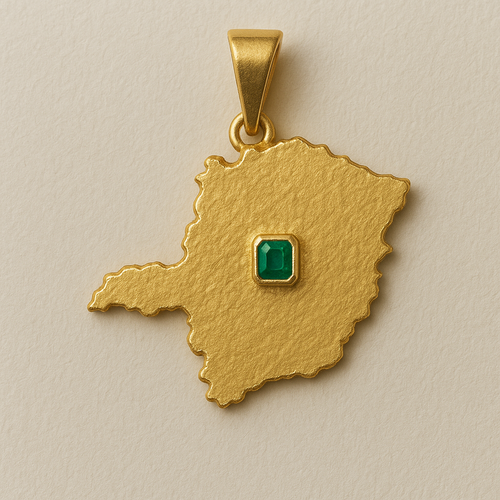 Gold pendant with a green gemstone on a beige background